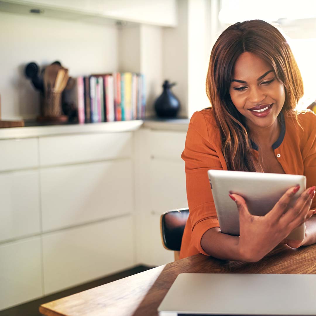 1080x1080Social-1 woman in office looking at tablet